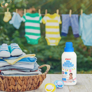Pigeon laundry detergent bottle with baby clothes and shoes on a wooden surface outdoors. Pigeon Baby Laundry Detergent Liquid 600ml go littles main image 7