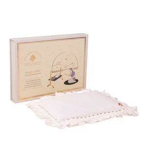 White
Somya Aakar Newborn’s Head-Shaping Mustard Pillow
embroidered pillow with a decorative box on a beige background