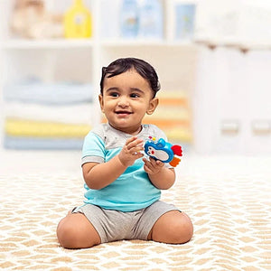 Child playing with a colorful toy in a nursery setting.  Funskool Giggles Baby's Gift Set at Go Littles product image 4