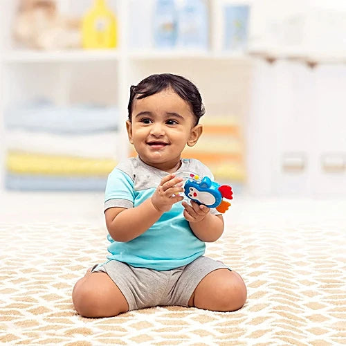 Child playing with a colorful toy in a nursery setting.  Funskool Giggles Baby's Gift Set at Go Littles product image 4