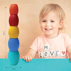 Giggles Funskool Stackable Blocks Barrels at go littles product image 4. Child with colorful stacking toys and text on shirt against a beige background