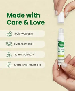Hand holding a bottle of Ayurvedic roll-on with product details on a light green background. Mother Sparsh Tummy Roll-On Hing & Sounf Oil, 6 ml go littles product main branch 4