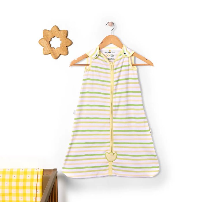 Striped baby sleeping bag on a hanger with a wooden toy and crib in the background. Nintara 0.5 TOG Sleep Sack - Citrus Stripes (M) 9 - 15 Months go littles product main image