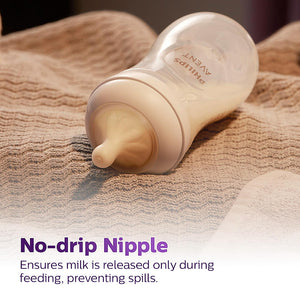 Baby bottle with no-drip nipple on a textured surface, featuring Avent branding. Philips Avent Teat Natural Response Teat SCY961/02  0m+ go littles product image 2